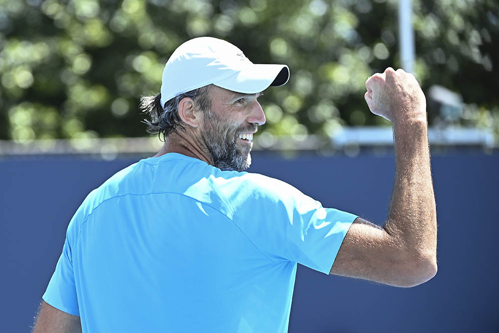 image: Ivo Karlovic on court and pumps fists