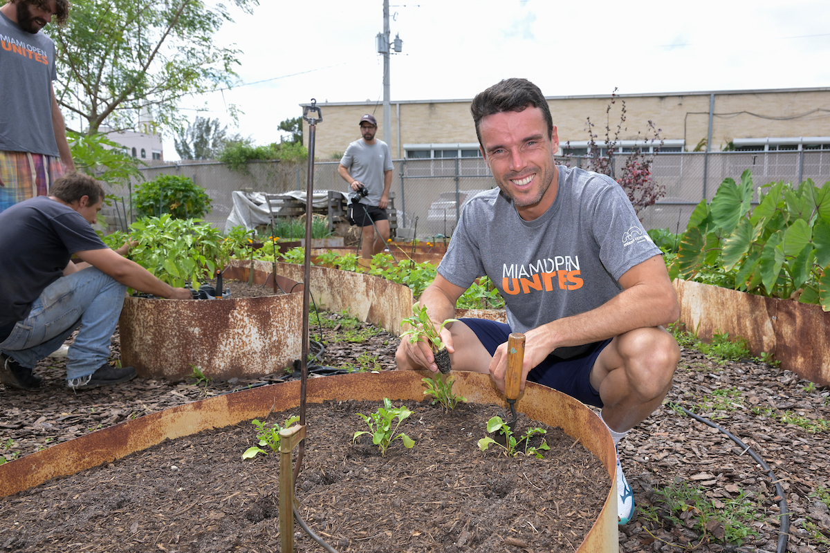 Roberto Bautista Agut of Spain works in community garden
