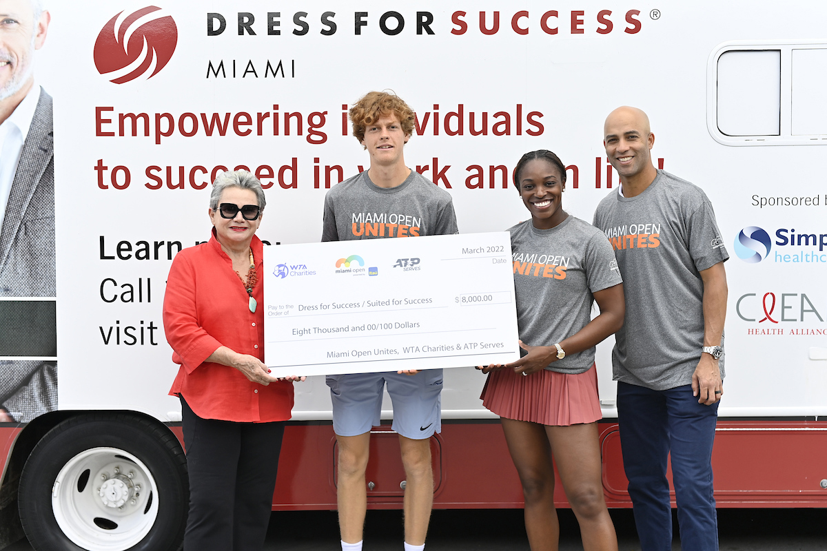 James Blake, Jannik Sinner and Sloane Stephens present a check to Suited for Success