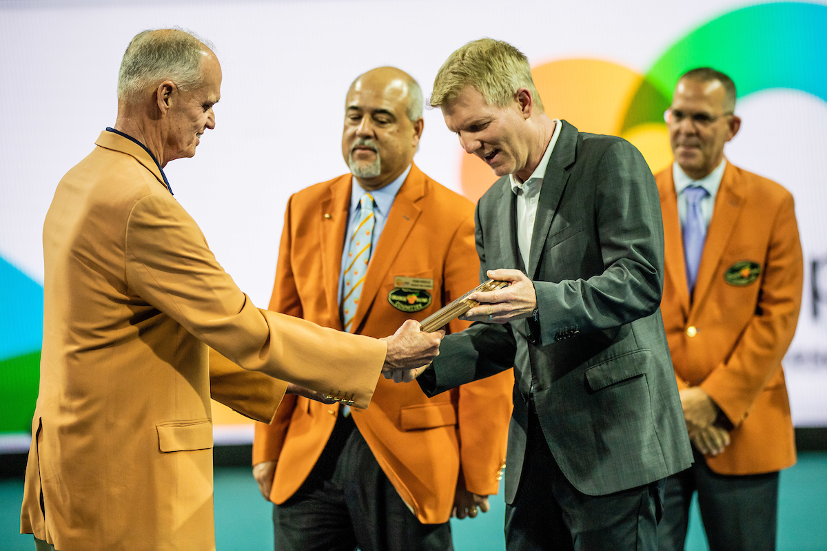 Jim Courier looking at plaque during Orange Bowl Hall of Fame Presentation