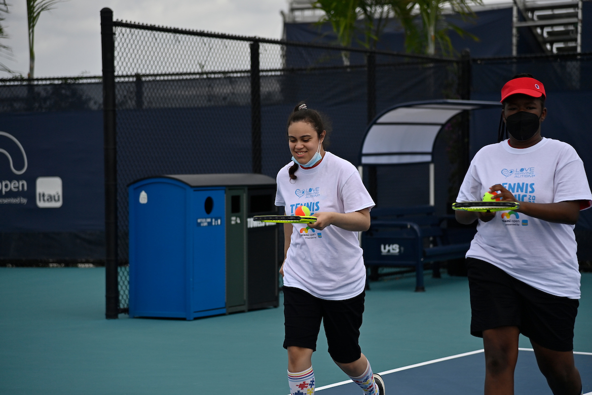 Love Serving Autism tennis clinic on practice court 17-19