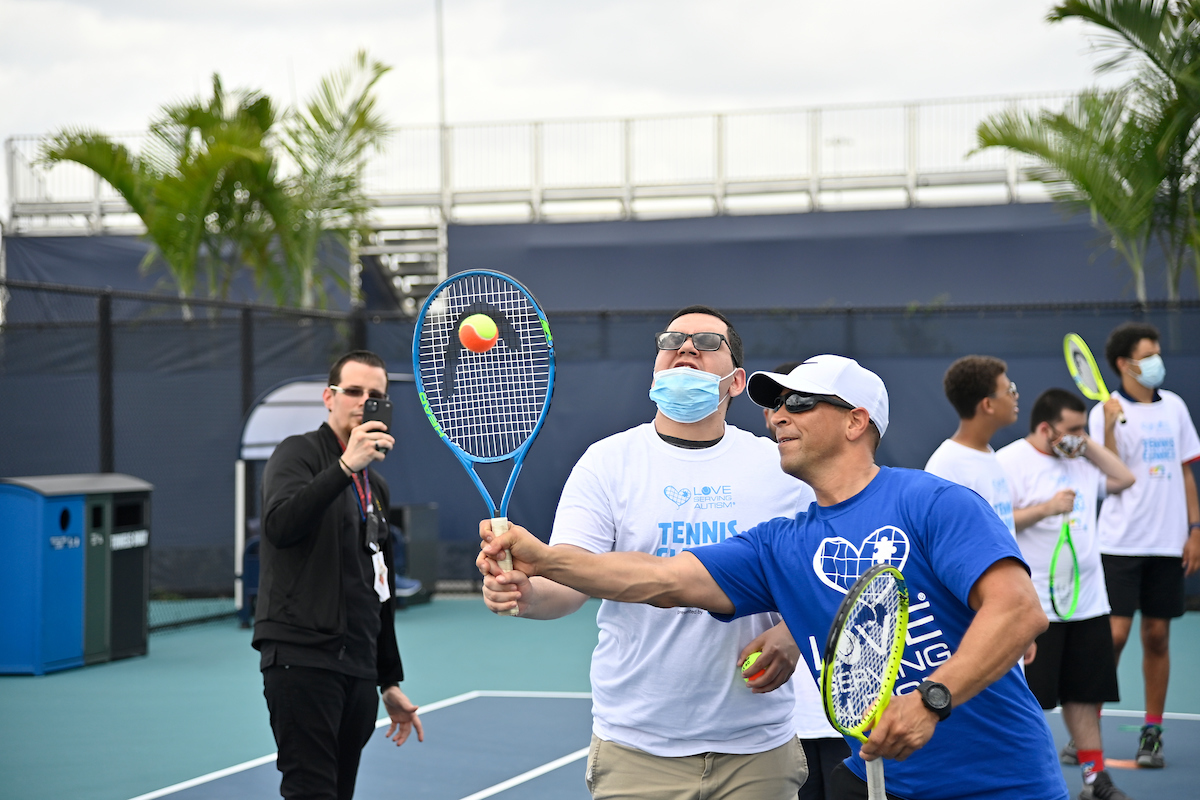 Love Serving Autism tennis clinic on practice court 17-19