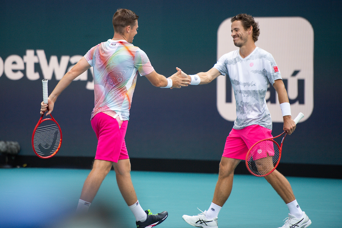 Wesley Koolhof and Neal Skupski high five during match