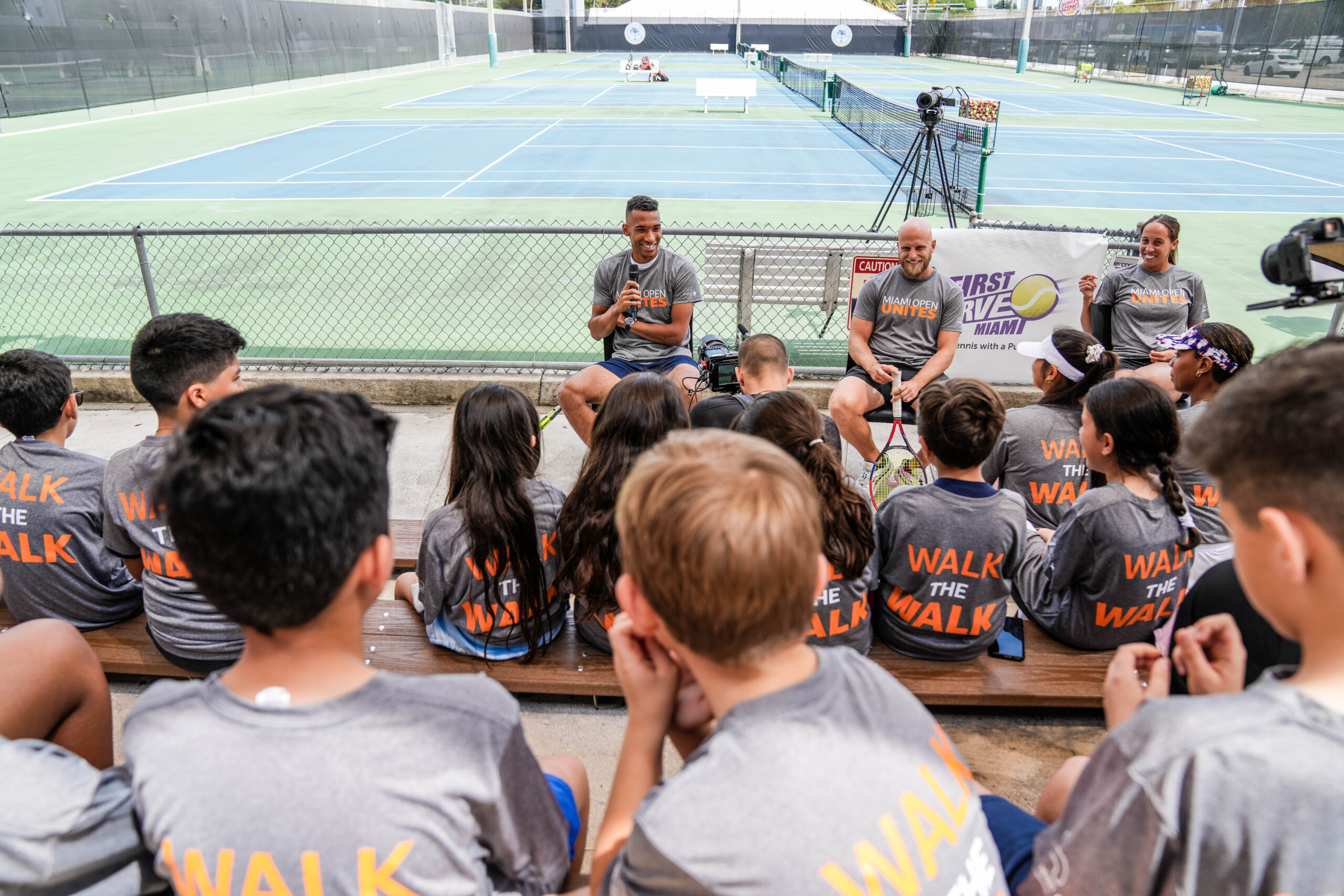 Felix Auger Aliassime, Denis Kudla and Madison Keys speak to the kids during the Big Brothers, Big Sisters event in Moore Park in Miami on March 20, 2023.