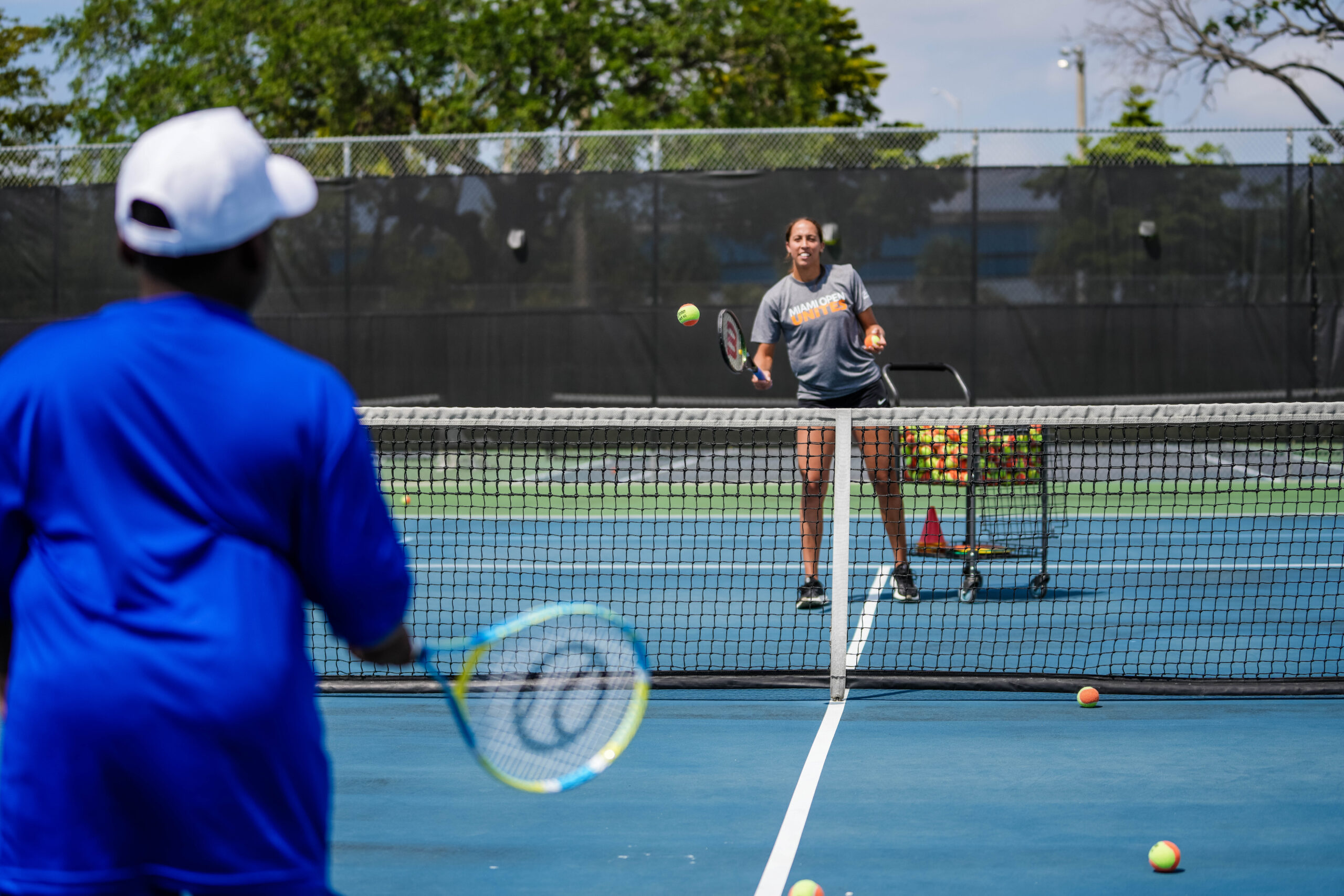 Madison Keys with on-court with participants of the tennis clinic at the Big Brothers, Big Sisters event at Moore Park in Miami on March 20, 2023.