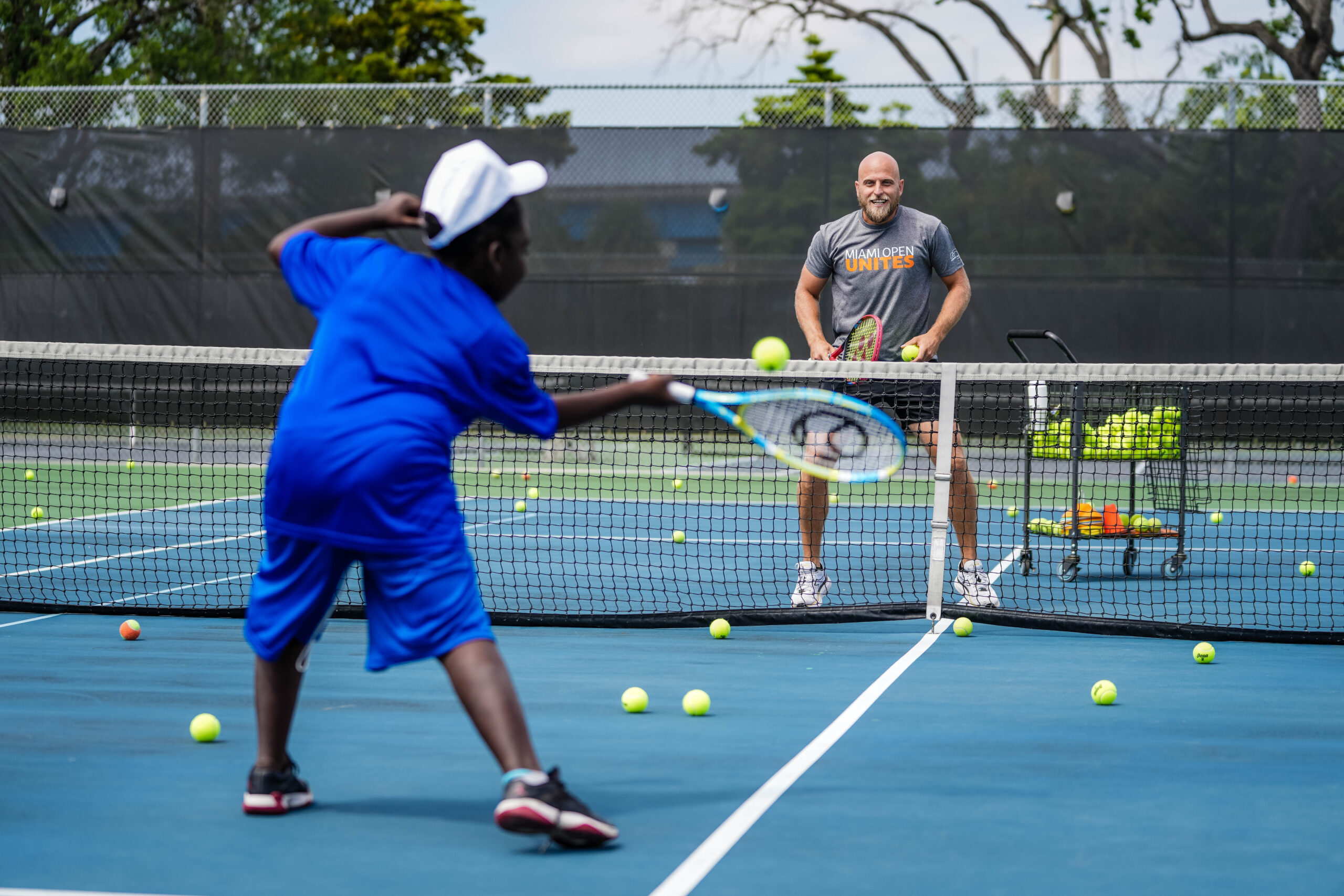 Denis Kudla on-court with participants of the tennis clinic at the Big Brothers, Big Sisters event at Moore Park in Miami on March 20, 2023.