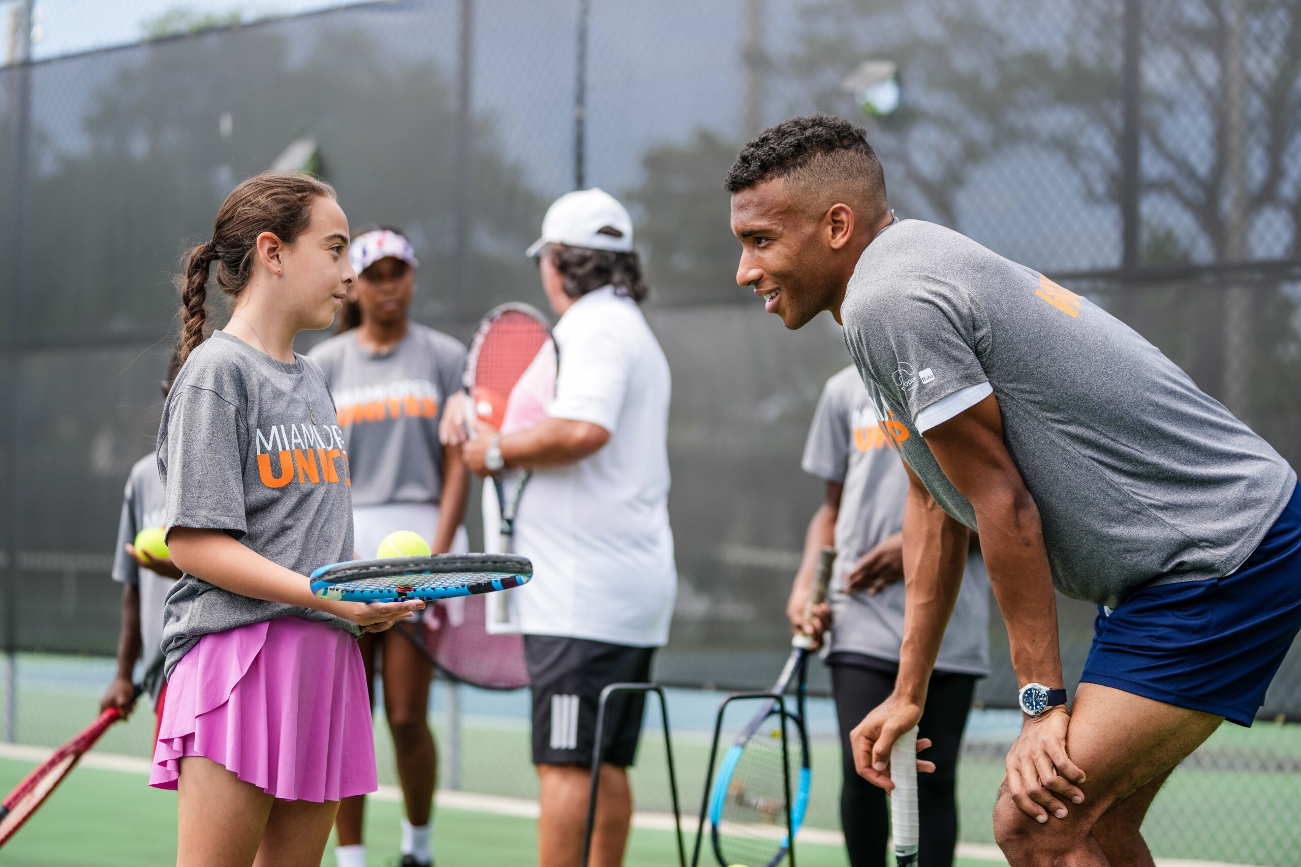 Felix Auger-Aliassime speaks to a participant of the Big Brothers, Big Sisters event at Moore Mark, Miami on March 20, 2023.