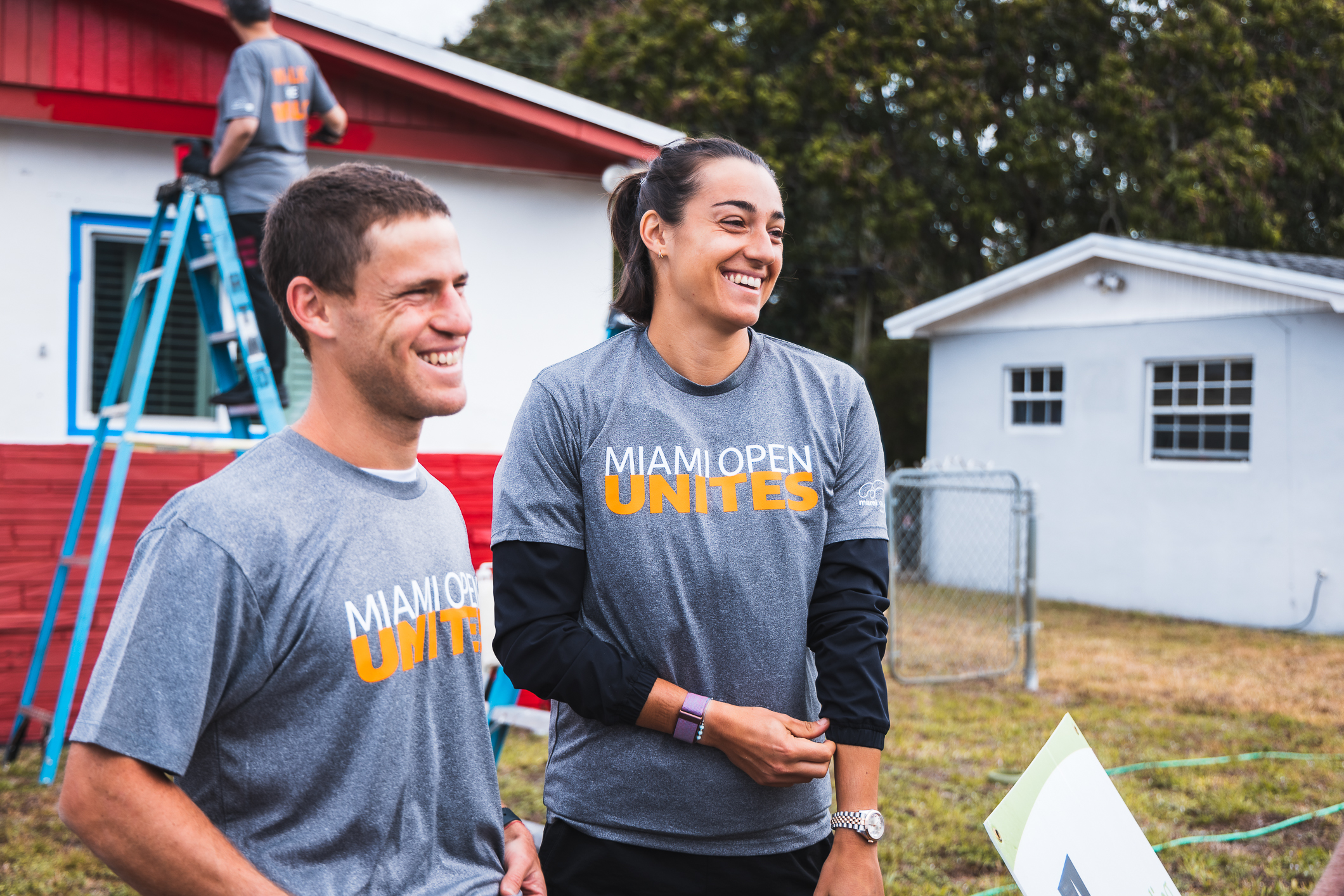 Diego Schwartzman and Caroline Garcia smile at the Miami Open Unites Rebuilding Together event in Miami on March 20, 2023.
