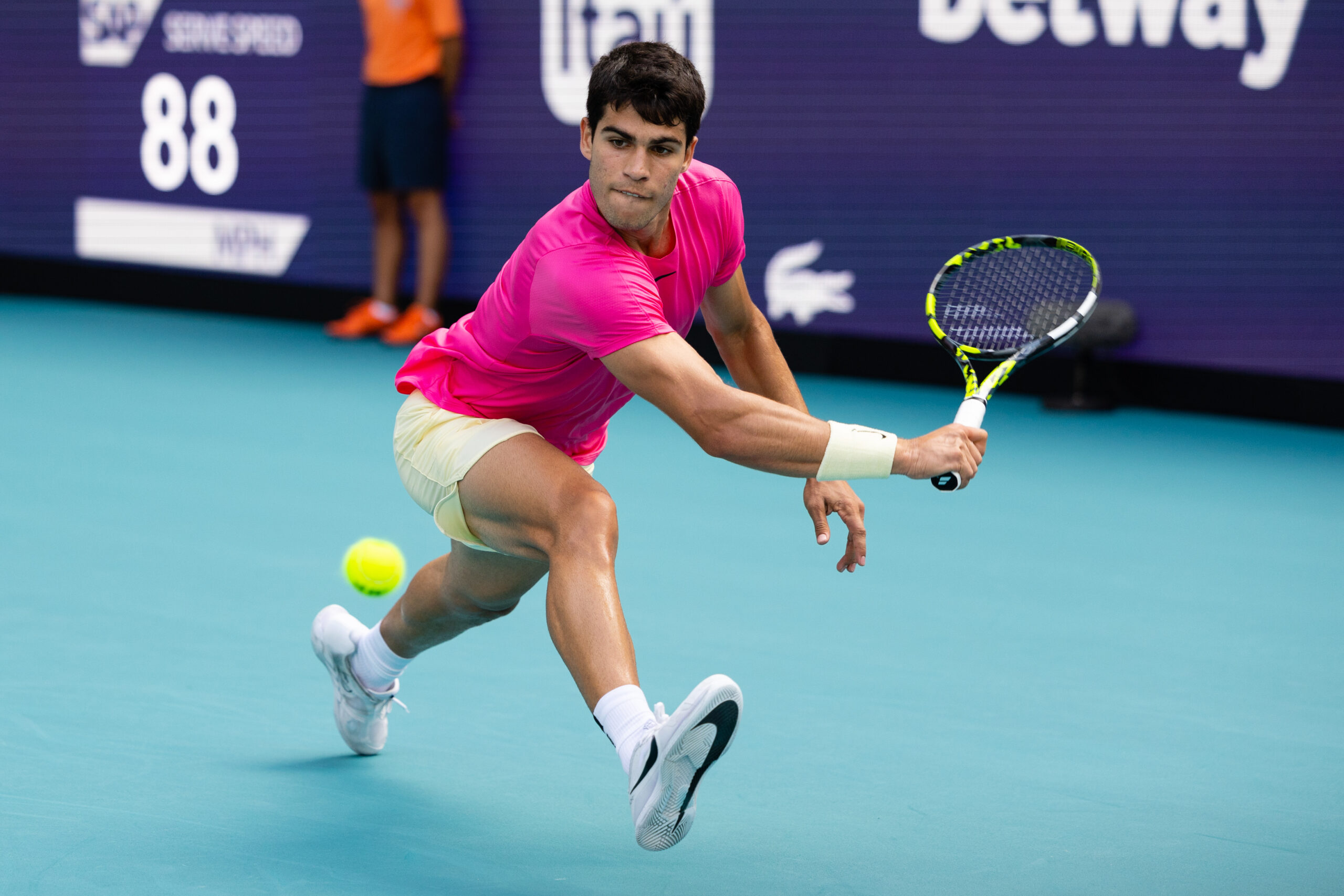 Carlos Alcaraz reaches down for a backhand slice during his match against Dusan Lajovic on March 26, 2023 at the Miami Open