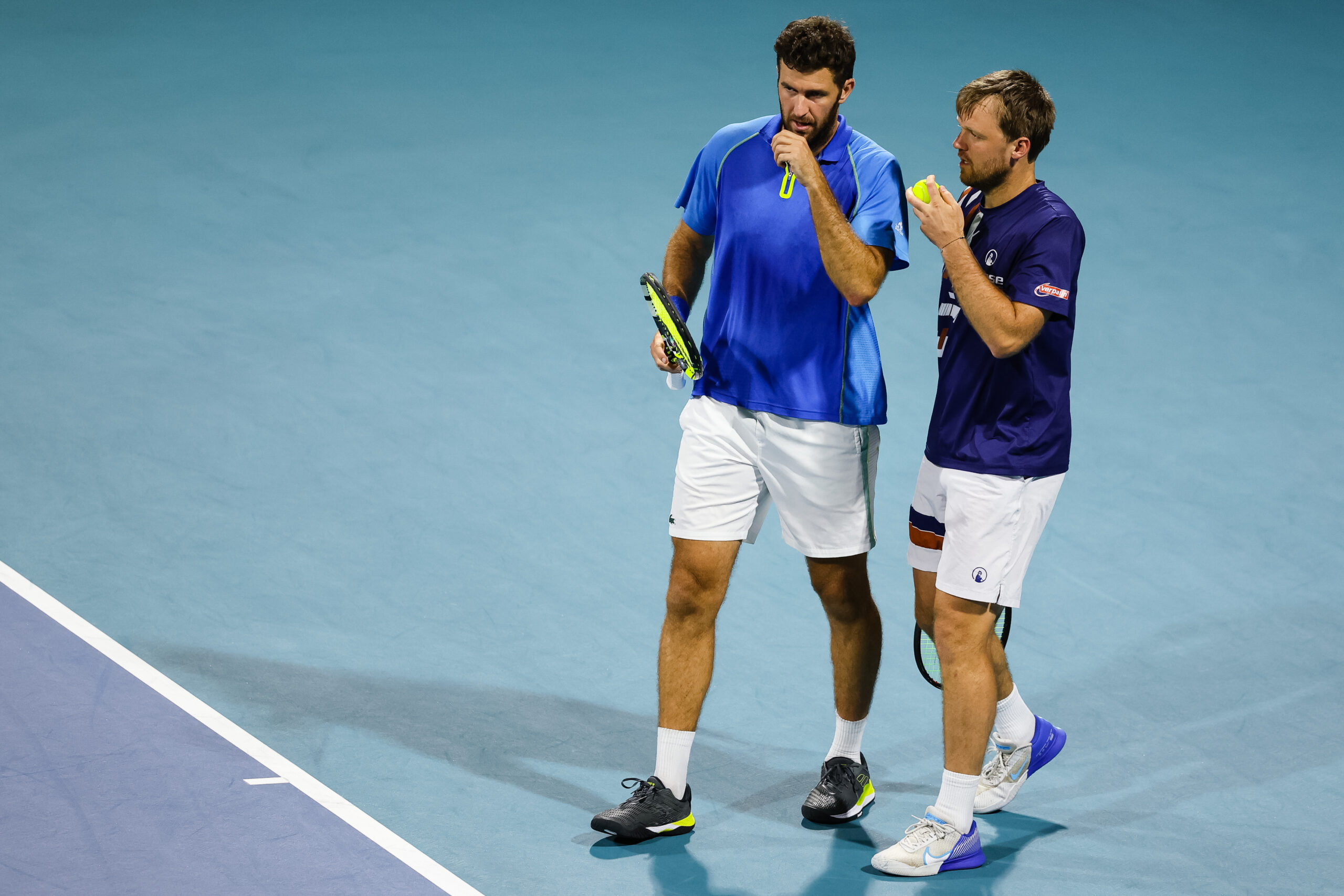 Fabrice Martin (left) and partner Kevin Krawietz discuss strategy during their semifinals doubles match at the 2023 Miami Open in Miami Gardens, Florida.