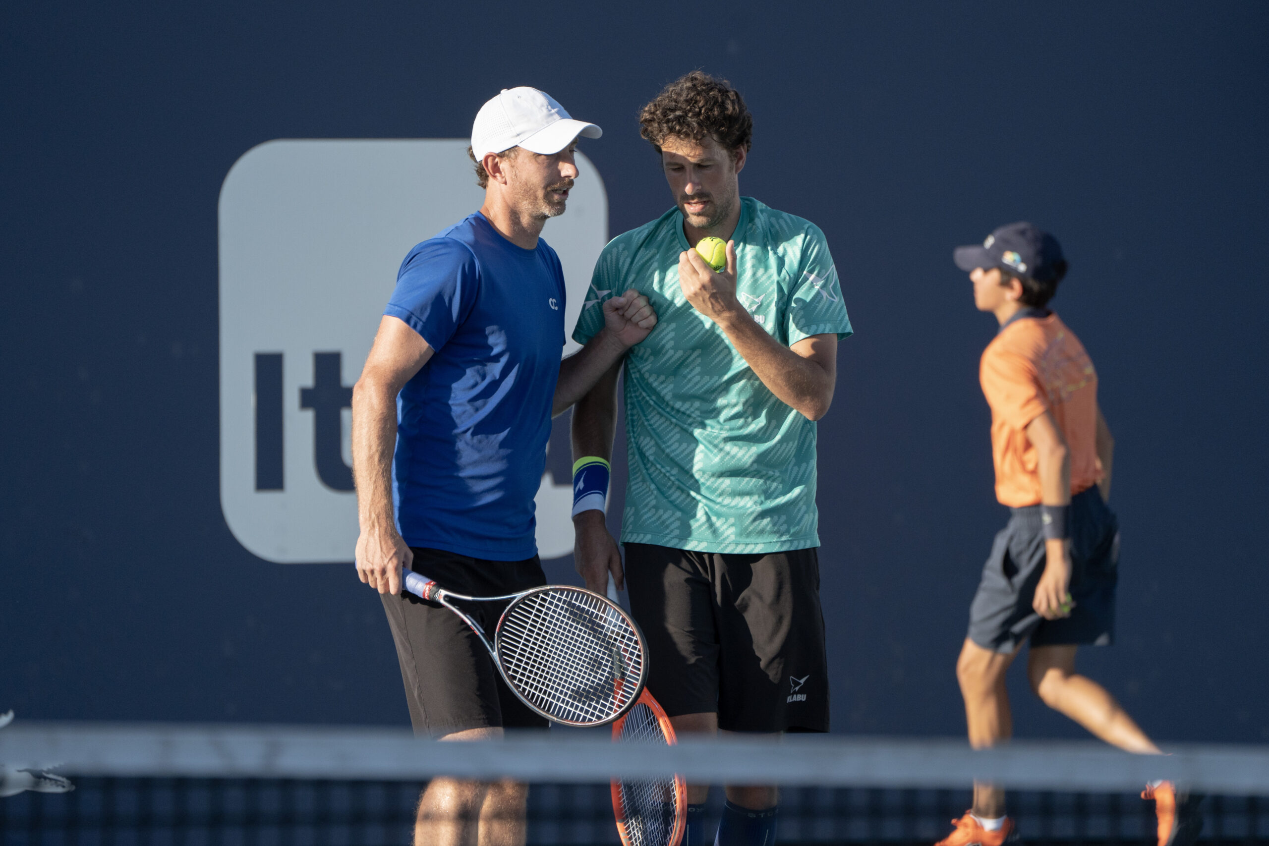 Matwe Middelkoop discusses strategy with partner Robin Haase at the 2023 Miami Open in Miami Gardens, Florida.