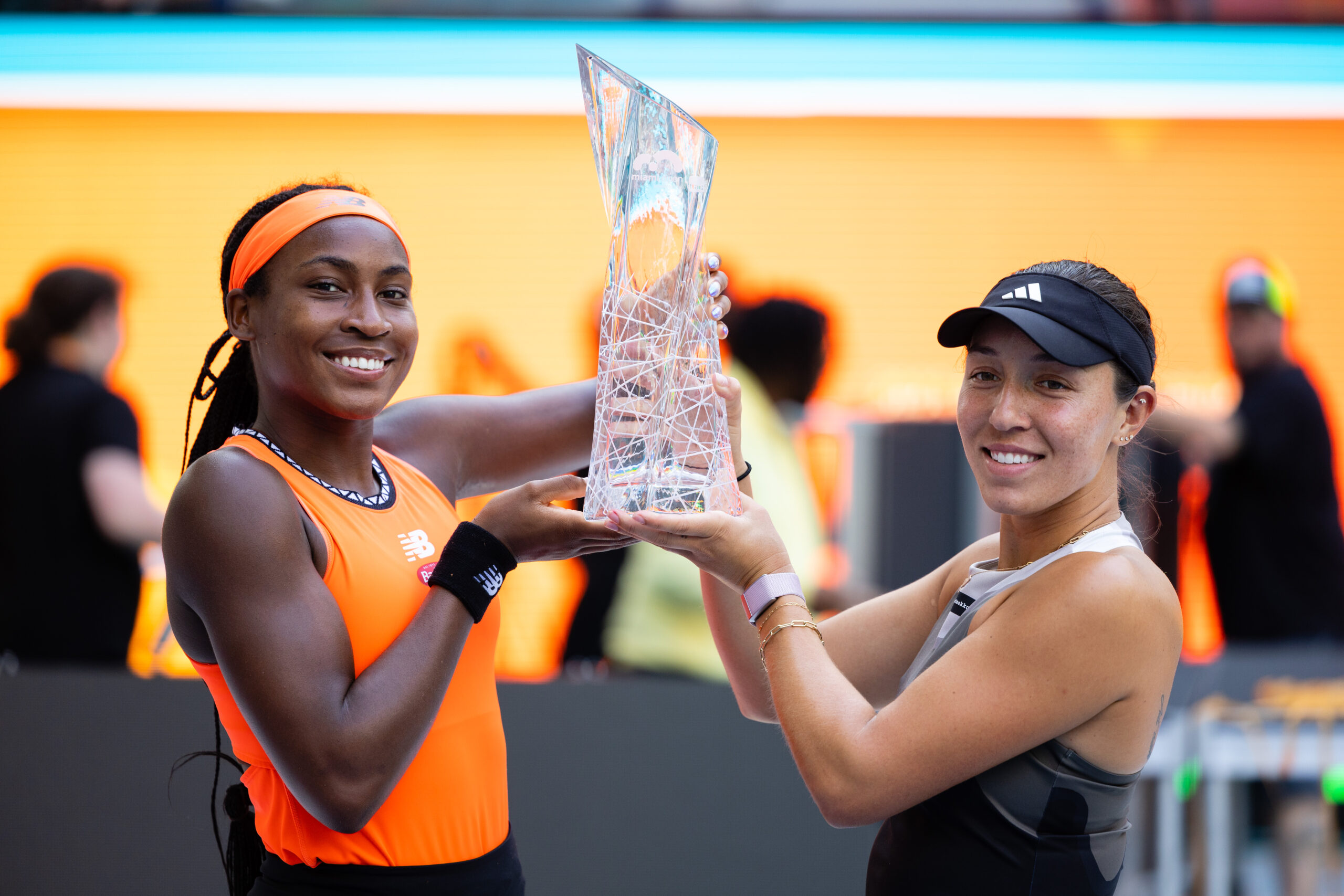 Coco Gauff and Jessica Pegula raise the 2023 Miami Open Women's Doubles Trophy at Hard Rock Stadium on April 2, 2023.