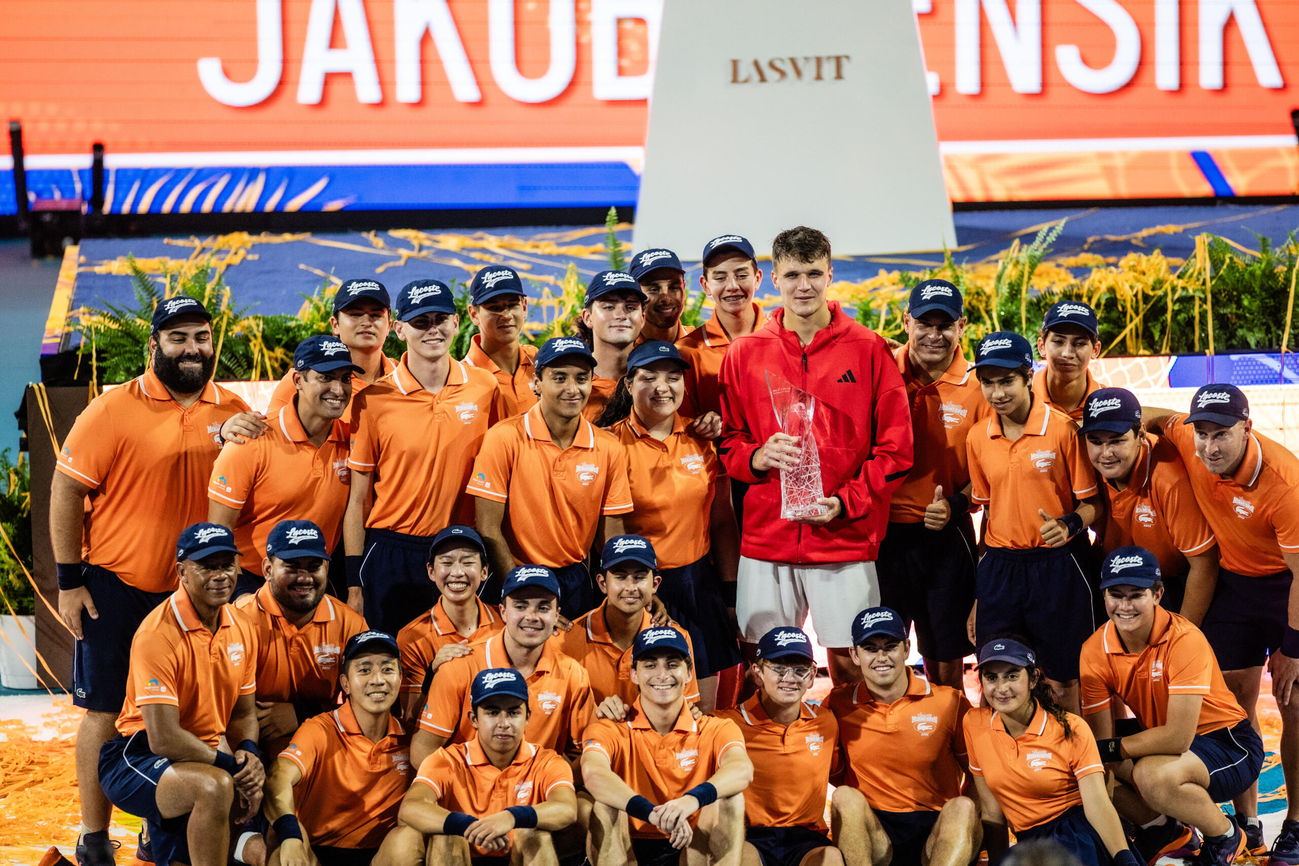 Ballpersons group posing with Miami Open champion for picture