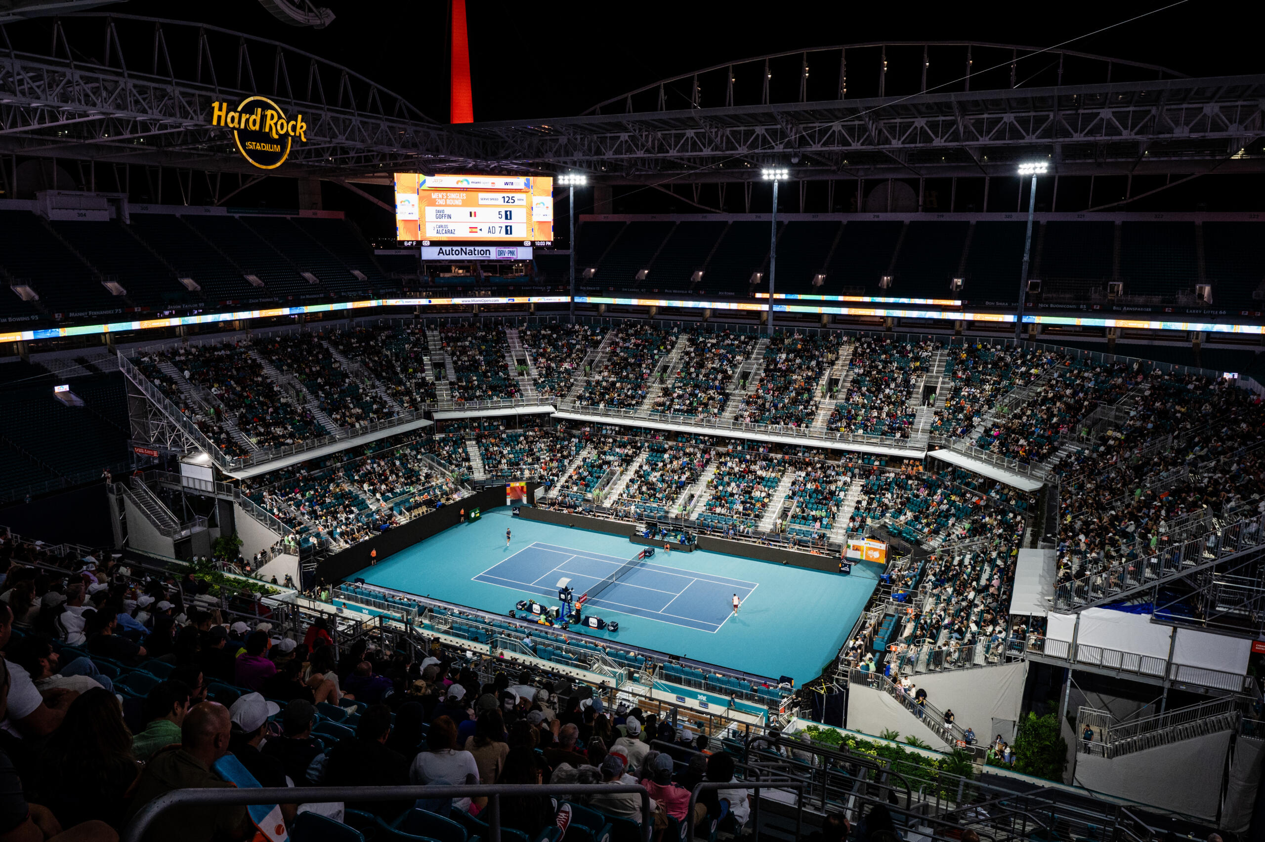 A wide shot of the Stadium Court at night with a full crowd.