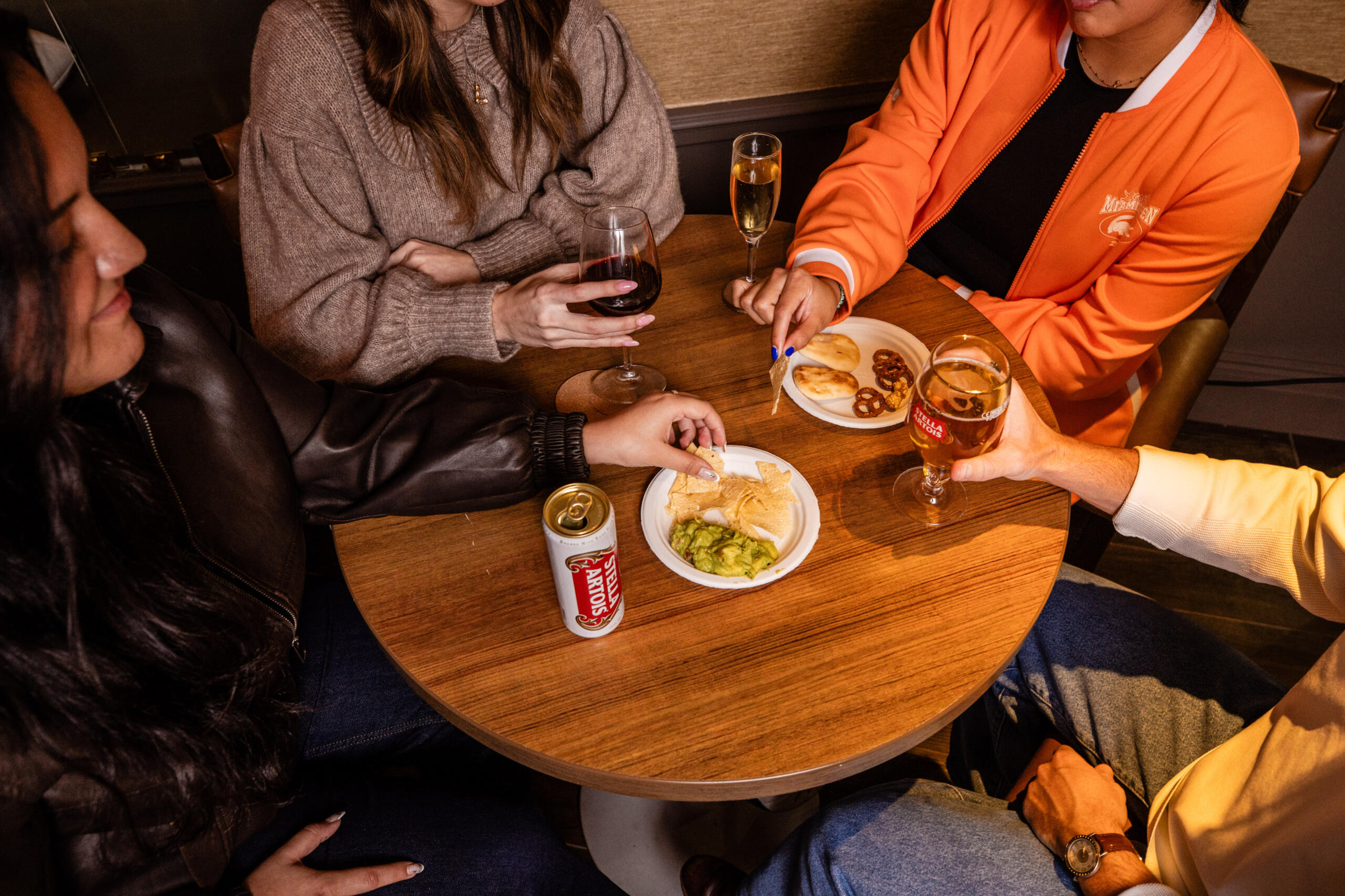 Overhead view of friends around a table snacking and drinking