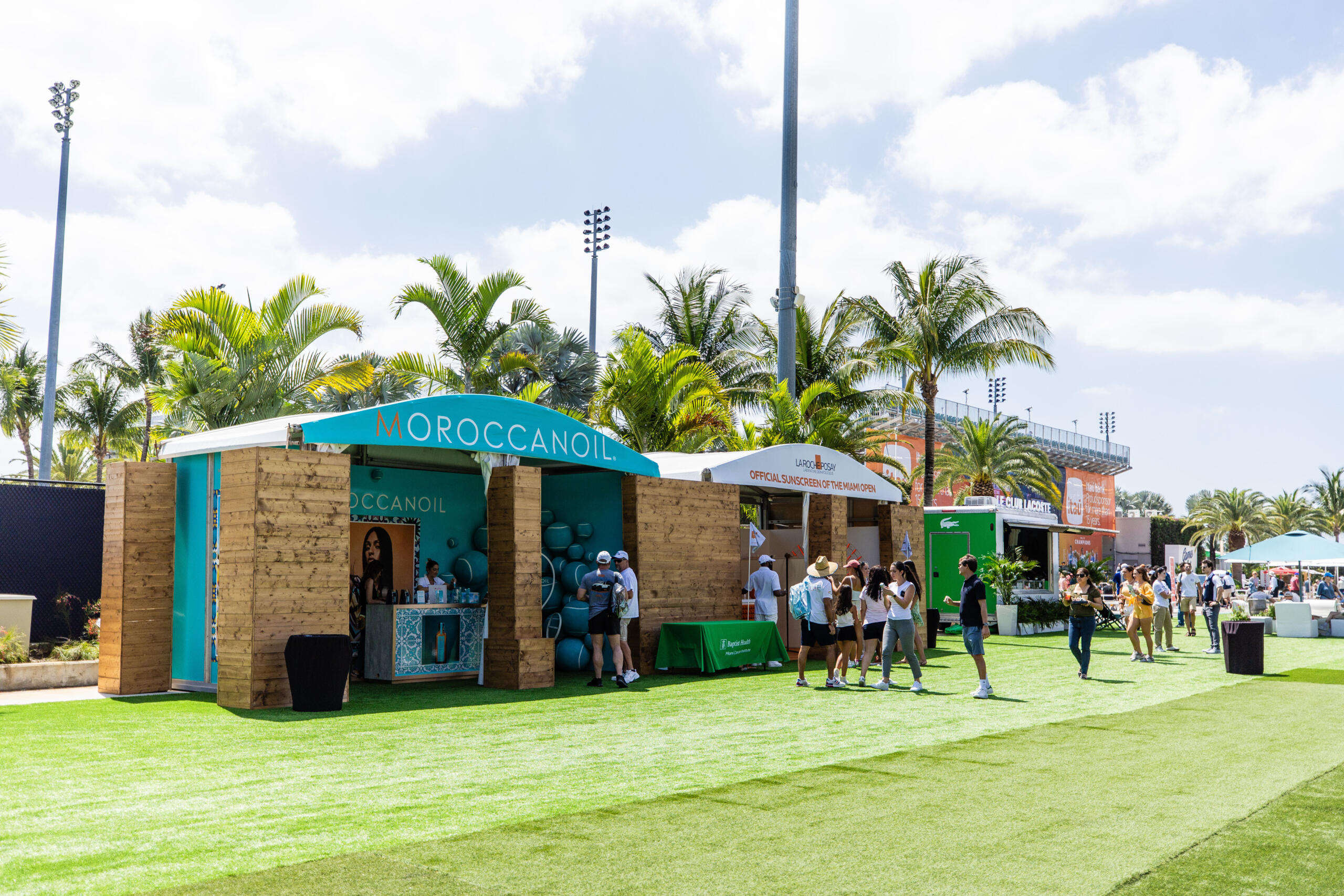 2024 Miami Open Wide shot of fans walking around campus and interacting with the partner booths. In the pictures, you can see booths of Moroccanoil and Laroche Posay