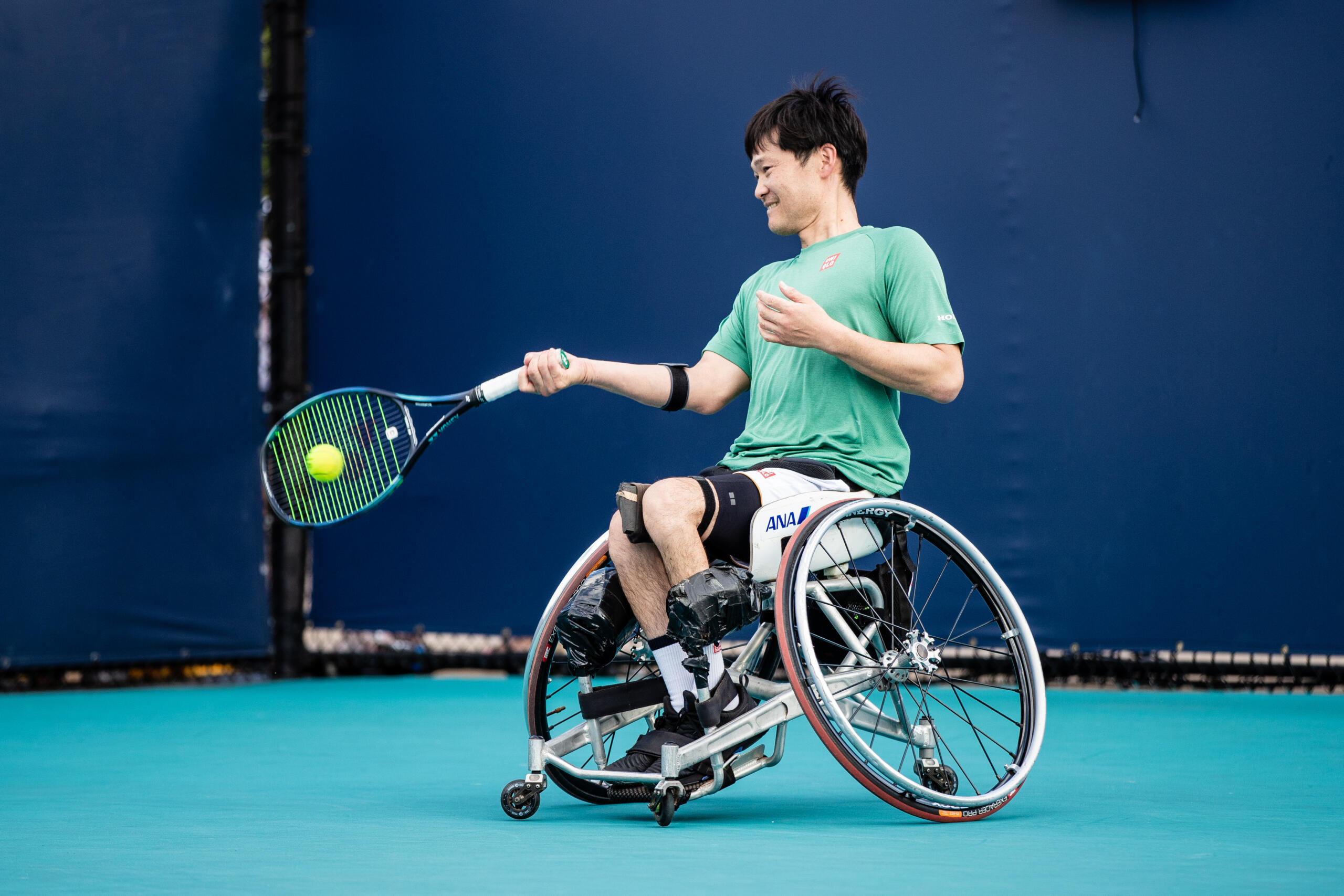 2024 Miami Open Wheelchair tennis player backhands the ball in a volley.