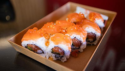 Close up image of a tay of sushi with salmon roe on top
