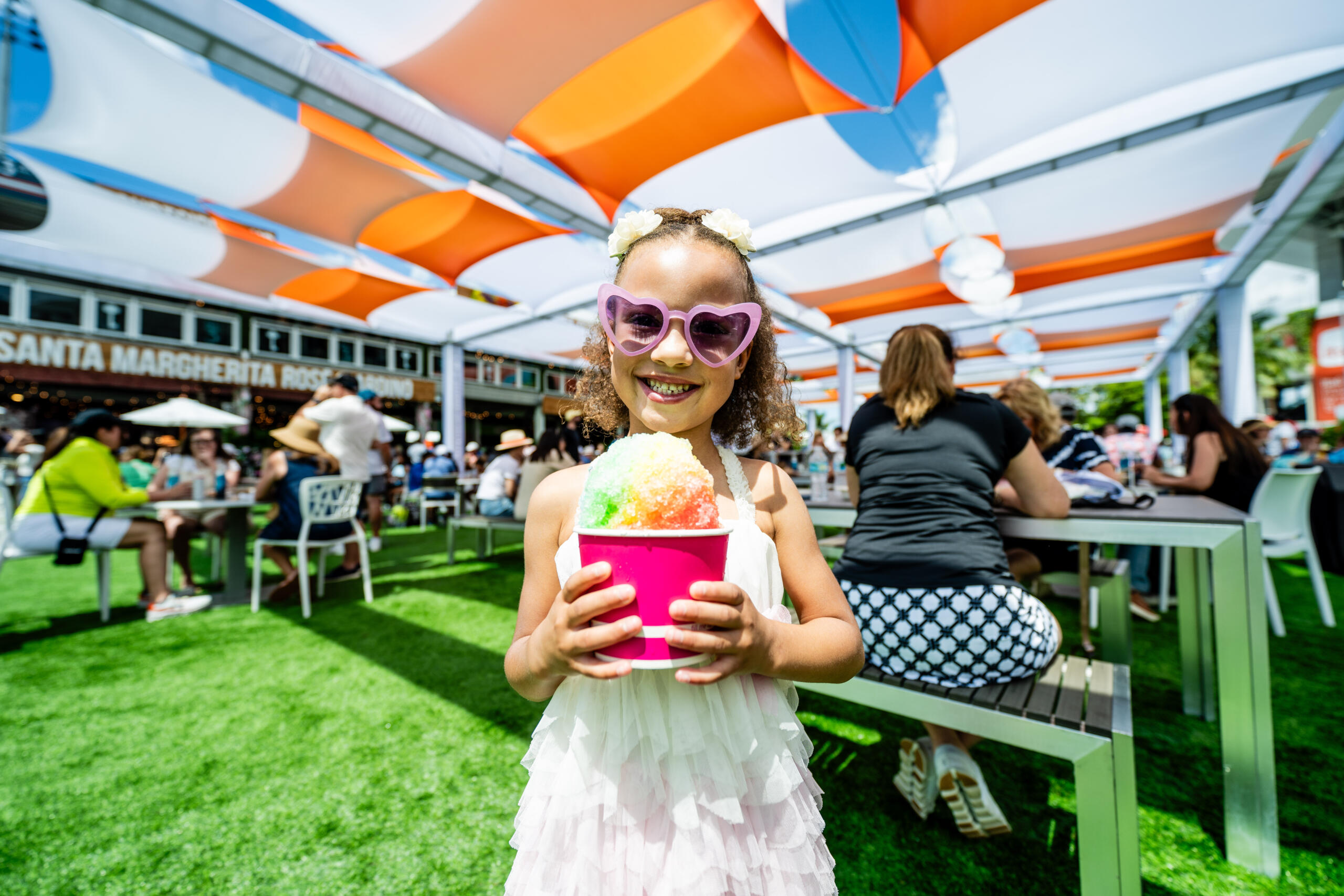Little girl smiles with shaved ice at the Miami Open