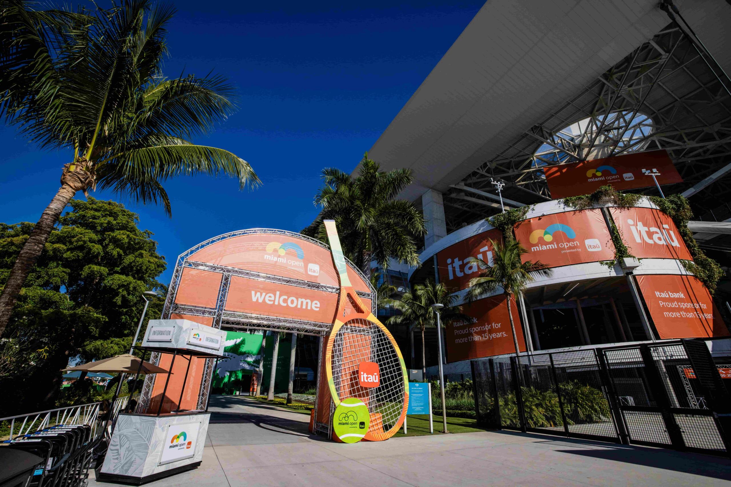 wide shot of Miami Open entrance with a welcome sign and a giant tennis ball and racket