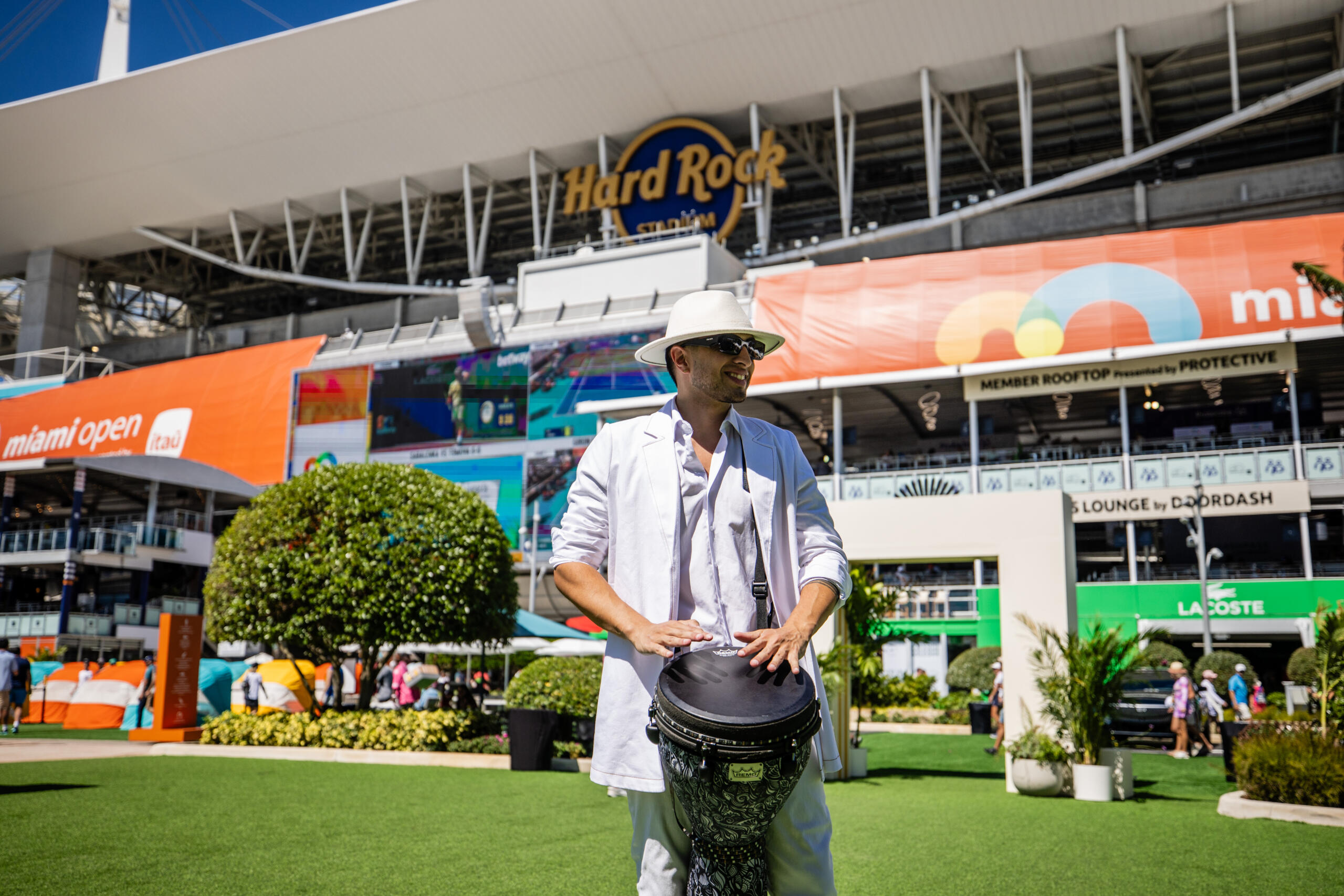 Hispanic drummer performs near the fountain aisles.