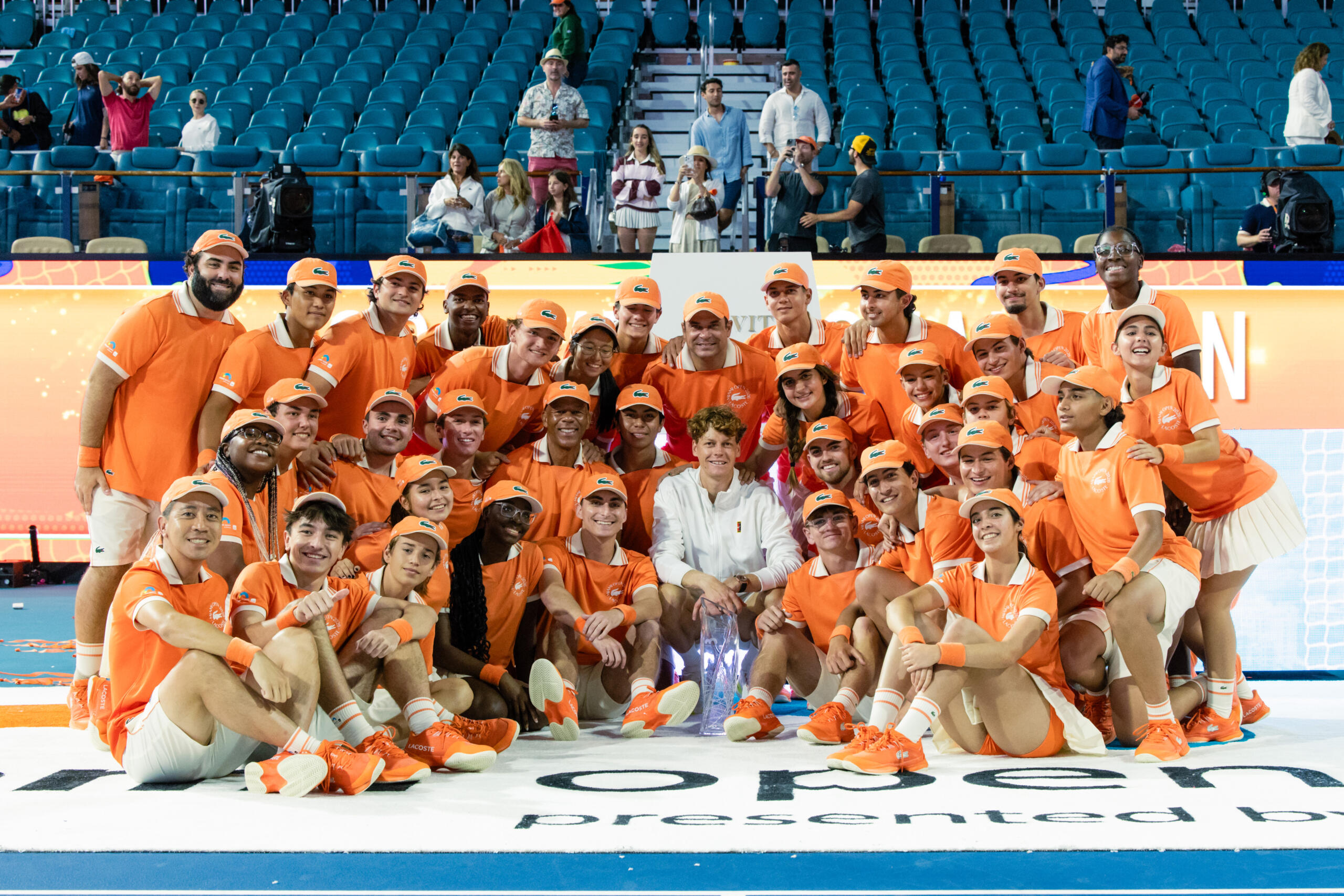 Ballperson's pose with a wheelchair tennis player.