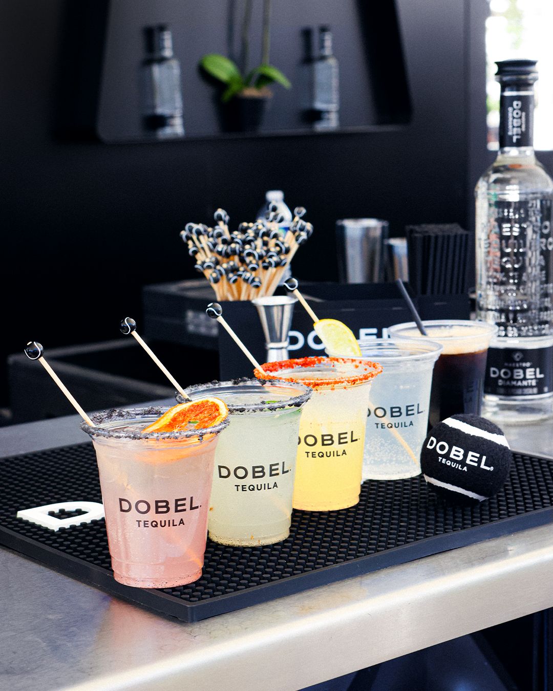 Dobel tequila drinks lined up on a bar.