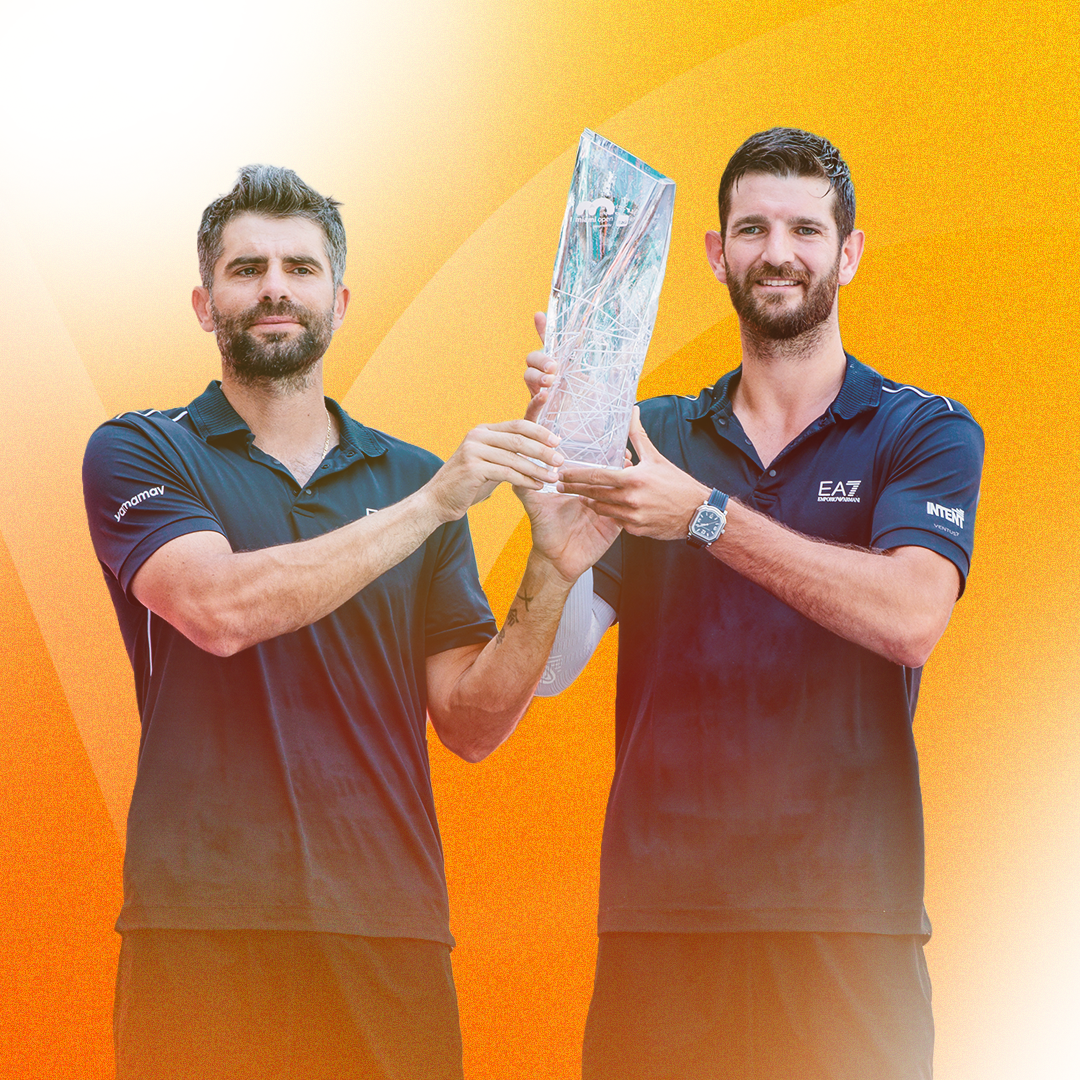 2026 Miami Open men's doubles champions Simonec Bolelli & Andrea Vavassori smile while holding their trophy together.