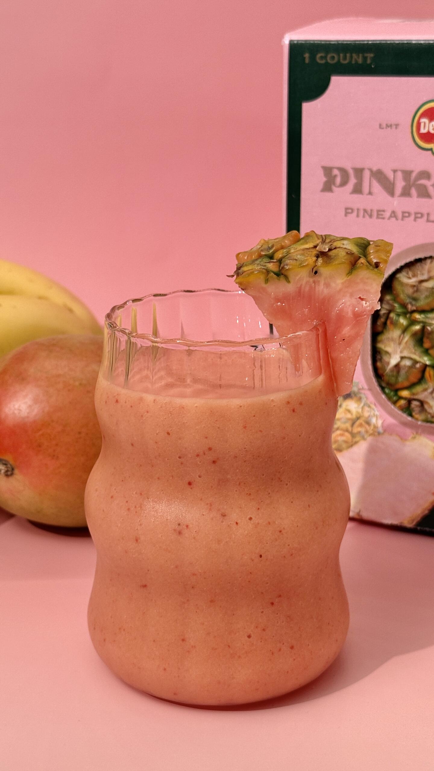 Pinkglow® Sunset Serve: A blend of mango, Pinkglow® Pineapple, banana, and coconut water, with a splash of orange juice