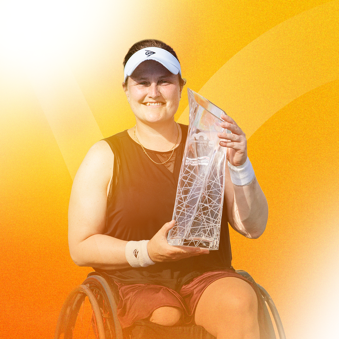 2025 Miami Open women's singles champion Aryna Sabalenka grins at her trophy following her victory.