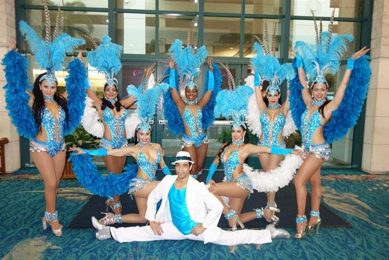 Brazilian dances in blue costumes pose for picture